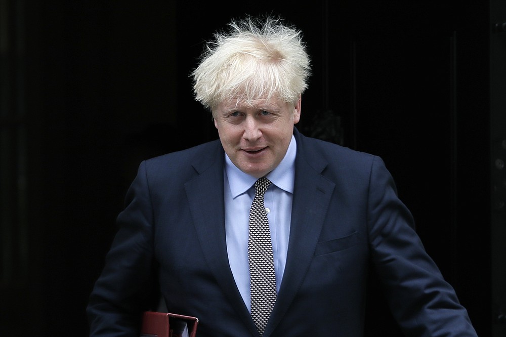 FILE - In this Wednesday, Sept. 9, 2020 file photo, Britain's Prime Minister Boris Johnson leaves Downing Street to attend the weekly session of Prime Ministers Questions in Parliament in London. British Prime Minister Boris Johnson has strongly defended his controversial plan to override sections of the Brexit deal that he negotiated with the European Union, arguing that the bloc has an “extreme” interpretation of the treaty that could jeopardize the future of the U.K. In a column Saturday, Sept. 12, 2020 in The Daily Telegraph, Johnson said the Internal Market Bill is required to end EU threats to impose a “blockade” in the Irish Sea that he argues could “carve up our country.” (AP Photo/Kirsty Wigglesworth, file)