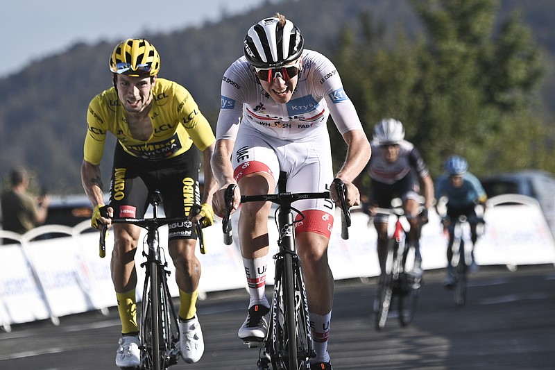 Slovenia's Tadej Pogacar, wearing the best young rider's white jersey, wins Sunday ahead of Slovenia's Primoz Roglic, wearing the overall leader's yellow jersey, left and second place, Australia's Richie Porte, third place and second rear right, and Colombia's Miguel Angel Lopez, four place, rear right, during stage 15 of the Tour de France, which runs over 174.5 kilometers (108.4 miles) from Lyon to Grand Colombier pass, France. - Photo by Christophe Petit-Tesson of The Associated Press story.lead_photo.caption