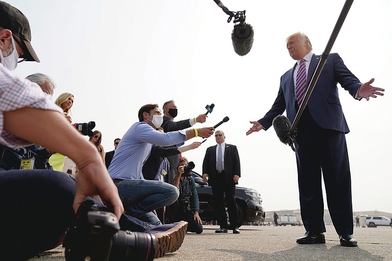 President Donald Trump speaks to reporters as he arrives at Sacramento McClellan Airport, in McClellan Park, Calif., Monday, Sept. 14, 2020, for a briefing on wildfires. (AP Photo/Andrew Harnik)