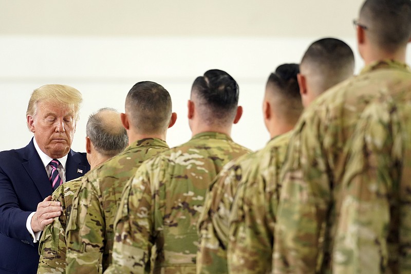 President Donald Trump participates in a ceremony recognizing the California National Guard at Sacramento McClellan Airport, in McClellan Park, Calif., Monday, Sept. 14, 2020, after being briefed on wildfires. (AP Photo/Andrew Harnik)