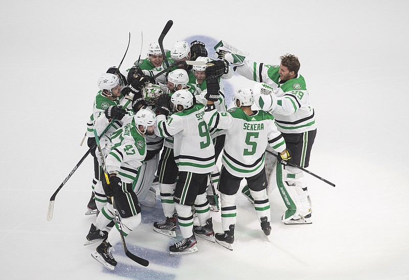Dallas Stars players celebrate their overtime win over the Vegas Golden Knights in Monday's NHL Western Conference final playoff game in Edmonton, Alberta. - Photo by Jason Franson/The Canadian Press via The Associated Press