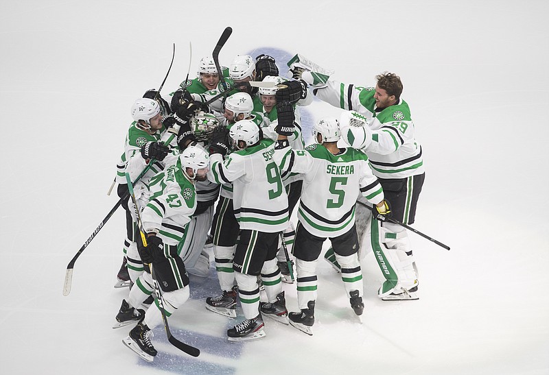 Dallas Stars players celebrate their overtime win over the Vegas Golden Knights in Monday's NHL Western Conference final playoff game in Edmonton, Alberta. - Photo by Jason Franson/The Canadian Press via The Associated Press story.lead_photo.caption