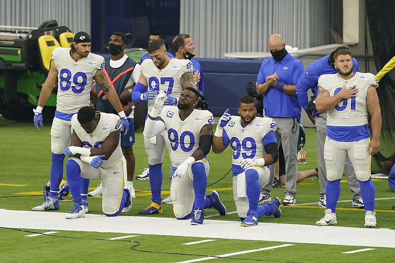 Members of the Los Angeles Rams stand and kneel during the national anthem before Sunday's NFL game against the Dallas Cowboys in Inglewood, Calif. - Photo by Ashley Landis of The Associated Press story.lead_photo.caption