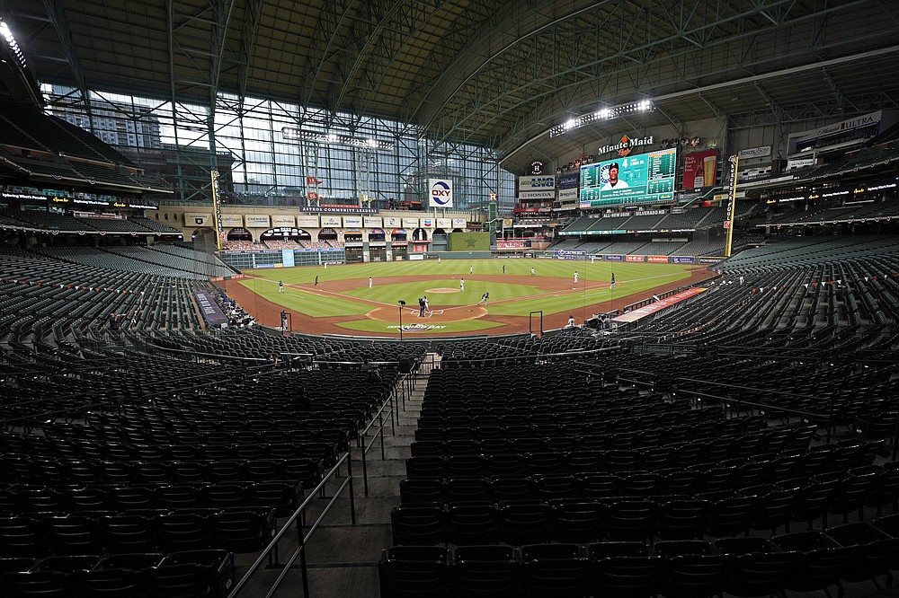 FILE - The Seattle Mariners play the Houston Astros in an empty Minute Maid Park during the first inning of a baseball game Friday, July 24, 2020, in Houston. The Division Series, League Championship Series and World Series will be part of a bubble designed to minimize exposure to the coronavirus. The AL Division Series will be at San Diego's Petco Park and Los Angeles’ Dodger Stadium, and the NL Division Series at Arlington's Globe Life and Houston’s Minute Maid Park. (AP Photo/David J. Phillip, File)