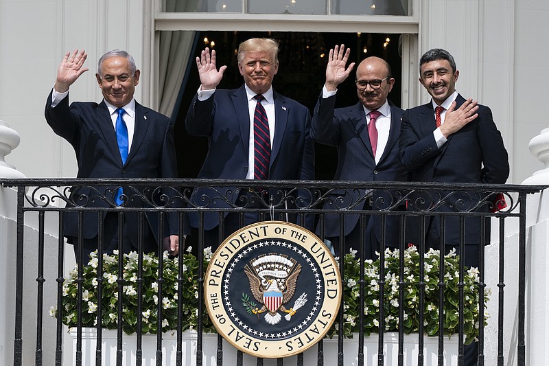 Israeli Prime Minister Benjamin Netanyahu, left, President Donald Trump, Bahrain Foreign Minister Khalid bin Ahmed Al Khalifa and United Arab Emirates Foreign Minister Abdullah bin Zayed al-Nahyan react on the Blue Room Balcony after signing the Abraham Accords during a ceremony on the South Lawn of the White House, Tuesday, Sept. 15, 2020, in Washington. (AP Photo/Alex Brandon)