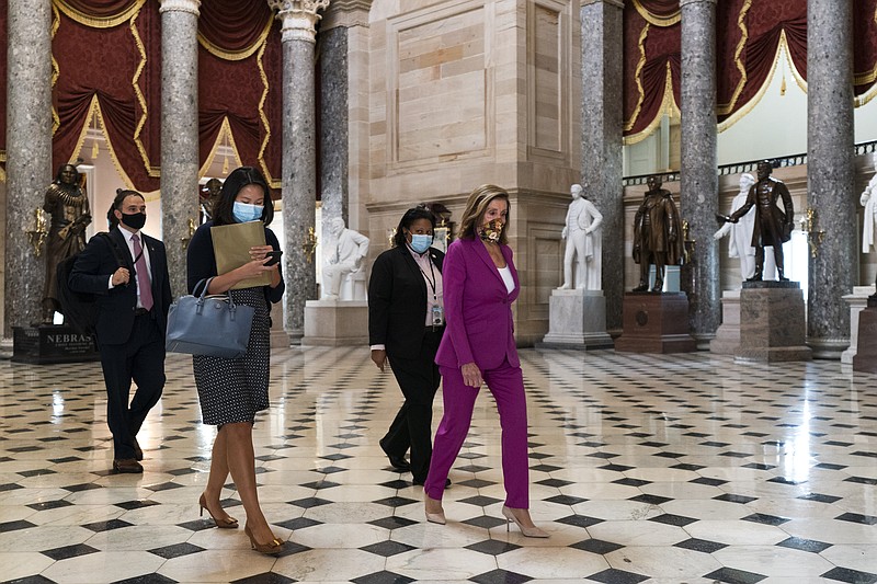 House Speaker Nancy Pelosi of Calif., right, walks to her office, Monday, Sept. 14, 2020, on Capitol Hill in Washington. (AP Photo/Jacquelyn Martin)