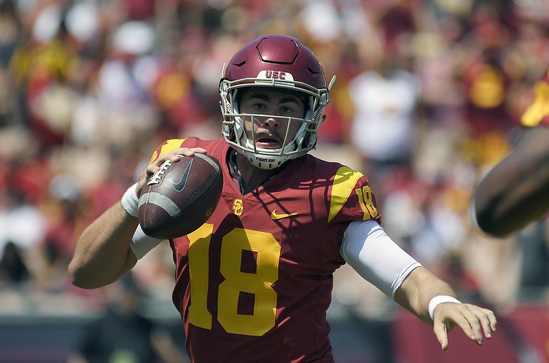 FILE - In this Sept. 1, 2018, file photo, then-Southern California quarterback Jt Daniels scrambles with the ball during the first half of an NCAA college football game against UNLV in Los Angeles. Two transfers, Jamie Newman, from Wake Forest, and JT Daniels, from Southern Cal, are names to watch in Georgia’s five-player quarterback competition. Newman may be the favorite as practice started Monday because Daniels is still recovering from a knee injury at USC.  (AP Photo/Mark J. Terrill, File)