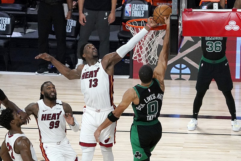 Miami Heat's Jimmy Butler, bottom left, and Jae Crowder (99) look on as Bam Adebayo (13) blocks a shot attempt by Boston Celtics' Jayson Tatum (0) in the closing seconds of overtime of an NBA conference final playoff basketball game, Tuesday, Sept. 15, 2020, in Lake Buena Vista, Fla. (AP Photo/Mark J. Terrill) story.lead_photo.caption