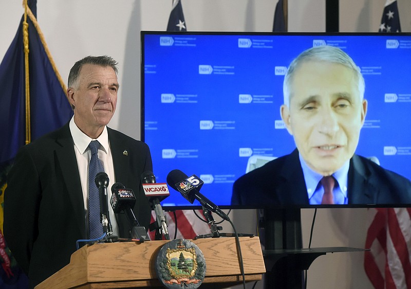 Vermont's Gov. Phil Scott, left, listens as Dr. Anthony Fauci, director of the National Institute of Allergy and Infectious Diseases, discusses Vermont's response to the COVID-19 pandemic during a press conference Tuesday, Sept. 15, 2020, in Montpelier, Vt. (Jeb Wallace-Brodeur/The Times Argus via AP)