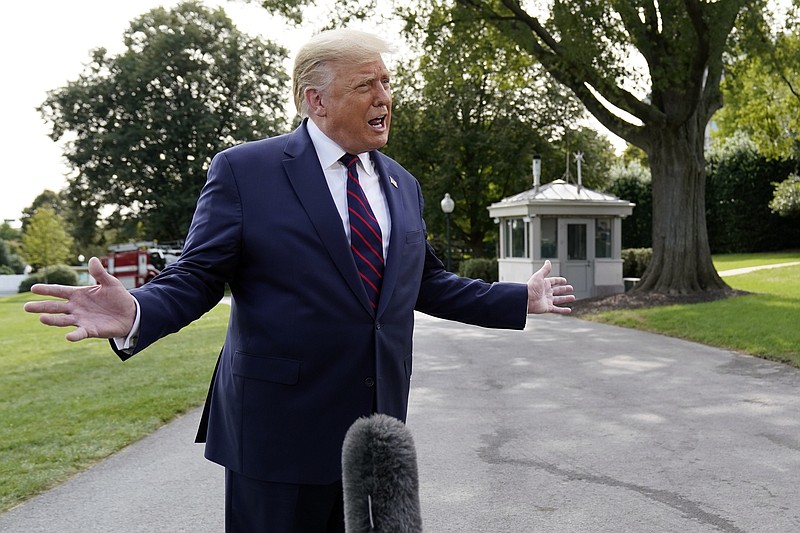 President Donald Trump speaks with reporters as he walks to Marine One on the South Lawn of the White House, Tuesday, Sept. 15, 2020, in Washington. Trump is en route to Philadelphia. (AP Photo/Alex Brandon)