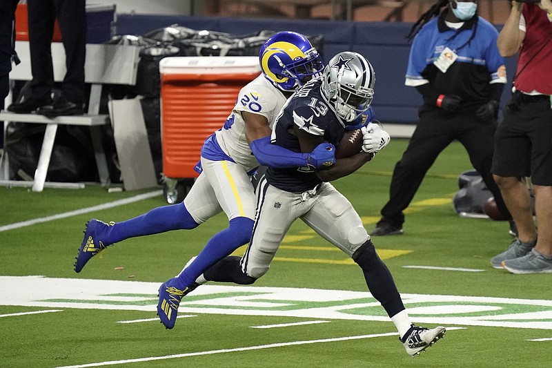 Dallas Cowboys wide receiver Michael Gallup (13) makes a catch but is called for offensive pass interference on Los Angeles Rams cornerback Jalen Ramsey, left, during the second half of Sunday's NFL game in Inglewood, Calif. - Photo by Jae C. Hong of The Associated Press story.lead_photo.caption
