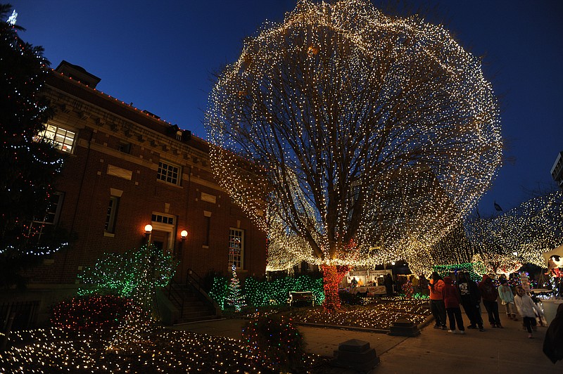 NWA Democrat-Gazette/ANDY SHUPE
Visitors walk Thursday, Dec. 29, 2016, while enjoying the annual Lights of the Ozarks display on the downtown square in Fayetteville. The display features more than 400,000 lights and will remain lit beginning at 5 p.m. through Saturday.