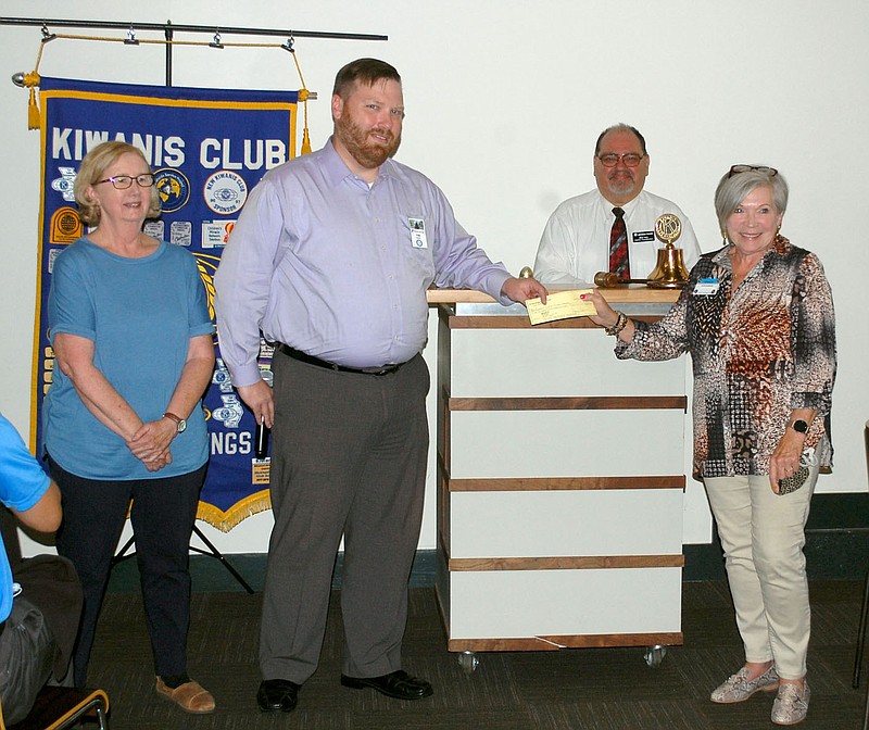 Janelle Jessen/Siloam Sunday
Mary Nolan (left), Rotary Club of Siloam Springs member, and Tim Davis, Rotary Club President, present a $1,200 check for Dolly Parton's Imagination Library to Mike Velo, Kiwanis Club president, and Katie Rennard, Kiwanis Club committee chair.