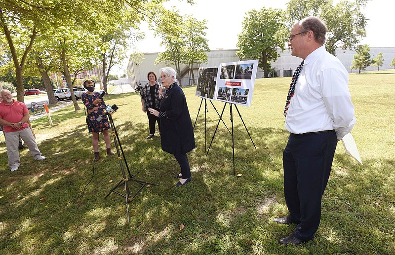 Joey McCutchen (right) hears remarks on Tuesday Sept. 15 2020 from Leah Whitehead (center) with the Benton County Historical Society at the site of the James H. Berry park in Bentonviile. The monument that was formerly on the Bentonville town square will be moved to the park. Go to nwaonline.com/200916Daily/ to hear more photos.
(NWA Democrat-Gazette/Flip Putthoff)