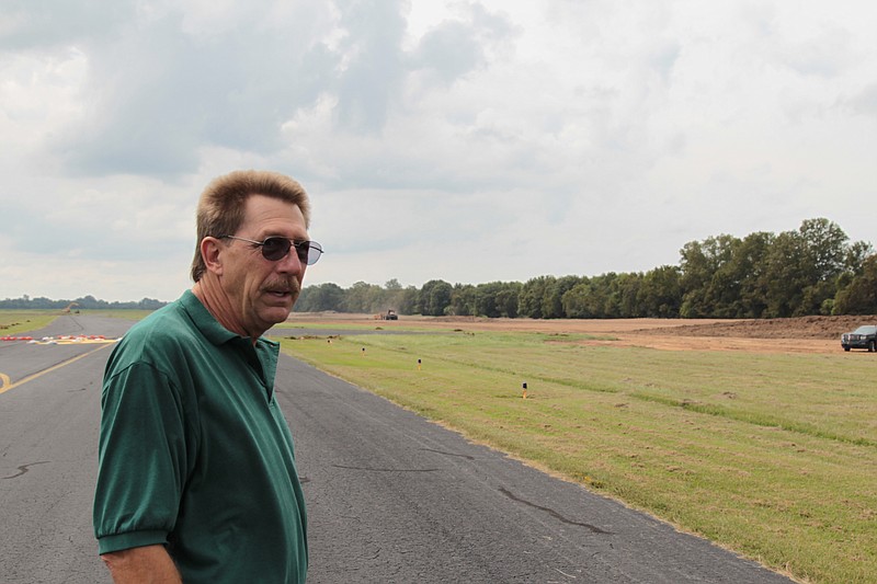 Doug Hale, manager of the Pine Bluff Municipal Airport at Grider Field, looks over a $2 million construction project currently underway to straighten out a bend in the airport taxiway. The bend, which was built into the original air field construction in 1947, is said to possibly be the result of a wartime measure. (Pine Bluff Commercial/Dale Ellis)