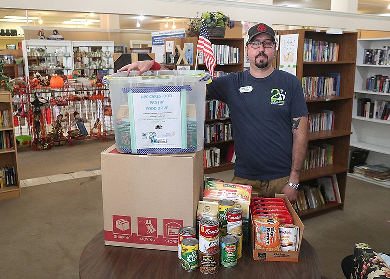 Romeo Lopez, Garland County Habitat for Humanity ReStore manager, with some of the food that has been donated at ReStore’s 350 Malvern Ave. location on Thursday. All three ReStores will collect donated food until Sept. 30. - Photo By Richard Rasmussen of The Sentinel-Record