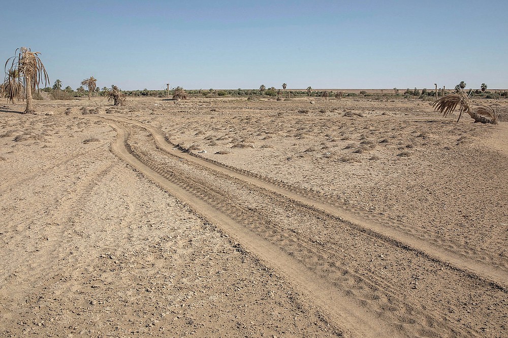 A barren wasteland that was once fertile and produced corn, cotton and wheat, in Second Village, Qouta town, Fayoum, Egypt, Wednesday, Aug. 5, 2020. Egypt's farmers already face severely stretched water resources due to years of mismanagement and increasing population. Now they worry about the impact of Ethiopia's massive dam project on the Blue Nile, the main tributary feeding the Nile River. No one is sure what effect the dam will have, but many farmers already see the Nile waters they once used to irrigate their fields diverted and they watch their fields drying up. (AP Photo/Nariman El-Mofty)