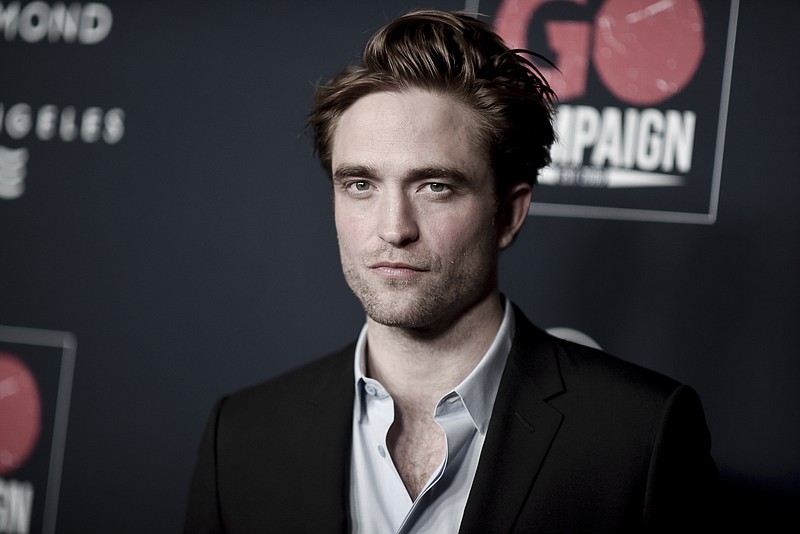 FILE - In this Nov. 16, 2019 file photo, Robert Pattinson attends the 13th Annual Go Gala at NeueHouse Hollywood in Los Angeles.  The U.K. production of “The Batman” starring Pattinson, is starting up again after being shut down earlier this month when an individual tested positive for COVID-19. A spokesperson for Warner Bros. said Thursday, Sept. 17, 2020,  that filming had resumed after a hiatus for quarantine precautions.  (Photo by Richard Shotwell/Invision/AP)
