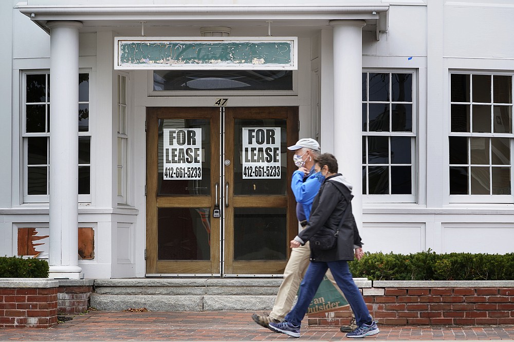 FILE - In this Sept. 2, 2020, file photo, shoppers pass by a former Clark's shoe store that is now one of several vacant retail spaces among the outlet shops in Freeport, Maine. The Labor Department reported unemployment numbers Thursday, Sept. 3. (AP Photo/Robert F. Bukaty, File)