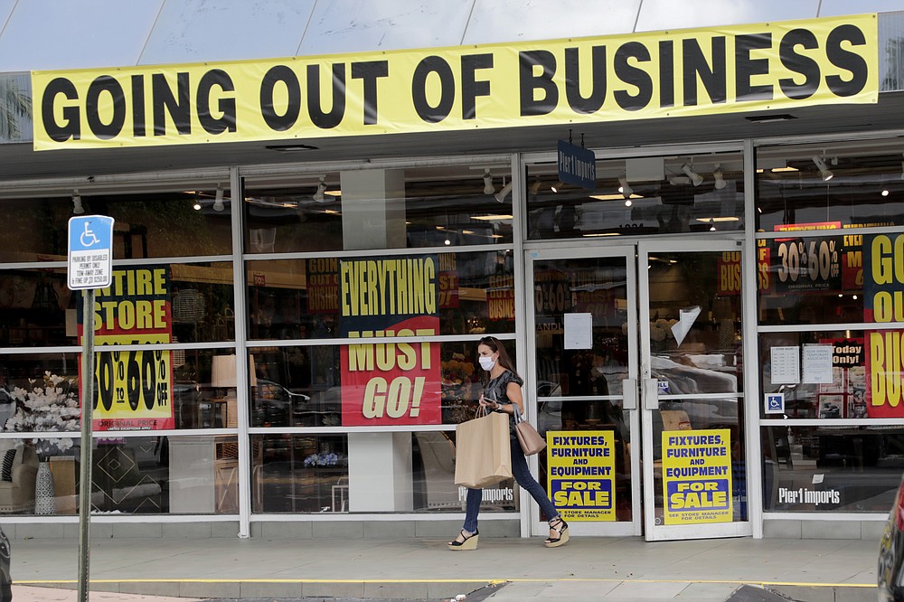 FILE - In this Aug. 6, 2020, file photo, a customer leaves a Pier 1 retail store, which is going out of business, during the coronavirus pandemic in Coral Gables, Fla. The Labor Department reported unemployment numbers Thursday, Sept. 3. (AP Photo/Lynne Sladky, File)