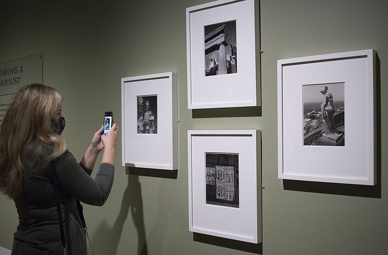 Jerra Nallie of Cave Springs looks at great depression era images from Ansel Adams, Monday, September 17, 2020 at Crystal Bridges in Bentonville. The new Ansel Adams temporary exhibition opens on Saturday. Check out nwaonline.com/200918Daily/ for today's photo gallery. 
(NWA Democrat-Gazette/Charlie Kaijo)