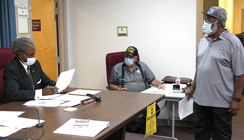 In this file photo from a recent Election Commission meeting, left to right, election commissioners Ted Davis and Mike Adam talk with Election Coordinator George Stepps. (Pine Bluff Commercial file photo/Dale Ellis)
