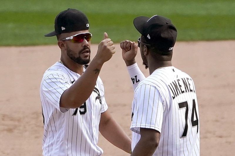 Chicago White Sox's Jose Abreu (79) and Eloy Jimenez celebrate the team's 4-3 win over the Minnesota Twins in a baseball game Thursday, Sept. 17, 2020, in Chicago. The White Sox clinched a playoff spot for the first time since 2008. (AP Photo/Charles Rex Arbogast)