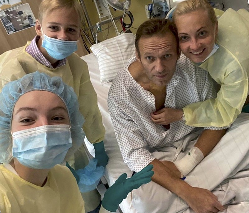 This handout photo published by Russian opposition leader Alexei Navalny on his instagram account, shows himself, center, and his wife Yulia, right, daughter Daria, and son Zakhar, top left, posing for a photo in a hospital in Berlin, Germany. Navalny has posted the picture of himself in a hospital in Germany and says he's breathing on his own. He posted on Instagram Tuesday: "Hi, this is Navalny. I have been missing you. I still can't do much, but yesterday I managed to breathe on my own for the entire day." - Navalny instagram via AP