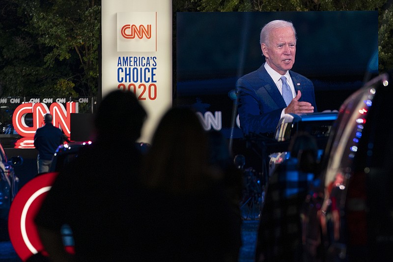 Audience members watch from their cars as Democratic presidential candidate former Vice President Joe Biden, seen on a monitor, speaks during a CNN town hall in Moosic, Pa., Thursday. - AP Photo/Carolyn Kaster