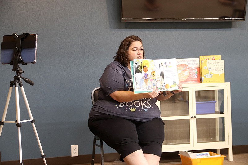 LYNN KUTTER ENTERPRISE-LEADER
Amanda Thulin, children's librarian for Prairie Grove Public Library, reads a book about kindergarten during Storytime last week. In addition to in-person Storytime, Amanda also is on Facebook Live at the same time.