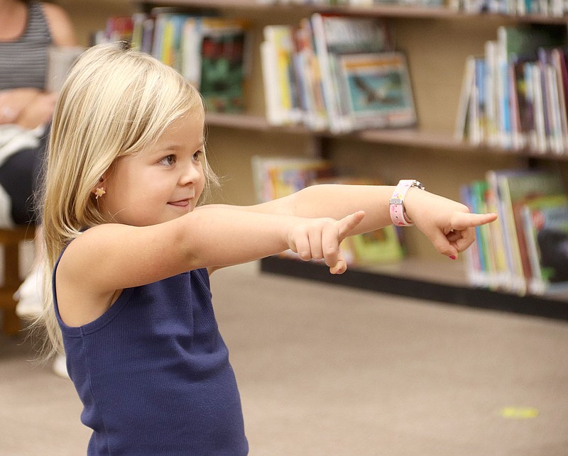 LYNN KUTTER ENTERPRISE--LEADER
Emma Bridges, 4, of Prairie Grove, sings during Storytime at Prairie Grove Public Library last week. The public sponsored its first in-person story time in six months. Previously, it's only been on Facebook Live because of concerns about the covid-19 pandemic.