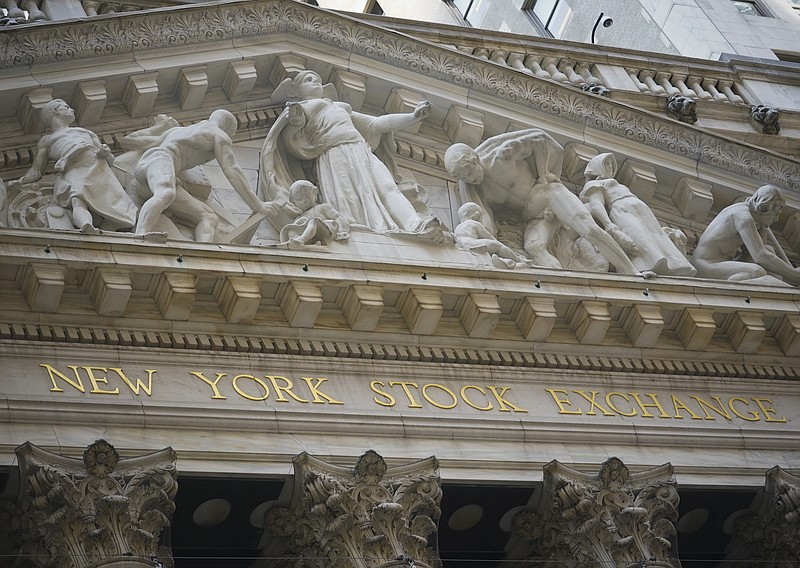 FILE - Marble sculptures occupy the pediment above the New York Stock Exchange signage, Tuesday Aug. 25, 2020, in New York.  Stocks are drifting in mixed trading on Wall Street Friday, Sept. 18, as another zig-zag week for markets closes out following their abrupt loss of momentum this month.(AP Photo/Bebeto Matthews, File)