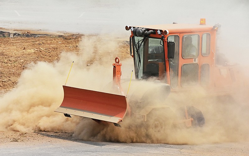 A dozer kicks up dust while working on the parking lot inside the westbound off-ramp loop to Arkansas 10/Cantrell Road and President Clinton Avenue. The closing is part of the 1 billion 30 Crossing project to remake the 6.7-mile corridor through downtown Little Rock and North Little Rock.
(Arkansas Democrat-Gazette/Staci Vandagriff)
