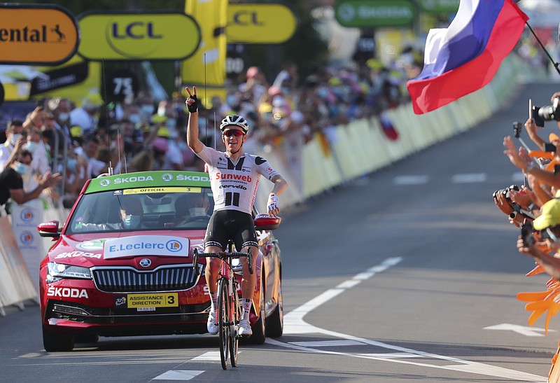 Denmark's Soren Kragh Andersen celebrates Friday as he crosses the line to win the 19th stage of the Tour de France cycling race over 166.5 kilometers (103.5 miles) between Bourg-En-Bresse and Champagole, France. - Photo by Marco Bertorello/Pool via The Associated Press