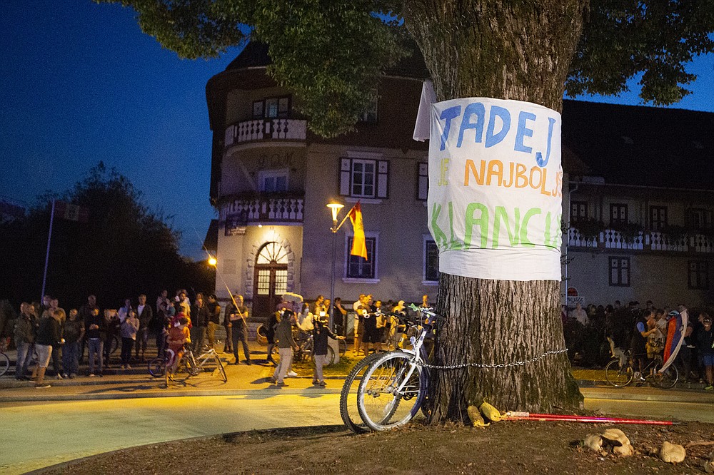 Supporters of Slovene cyclist Tadej Pogacar celebrate his victory at the Tour De France in his hometown of Komenda, central Slovenia, Saturday, Sept. 19, 2020. In an incredible climax to the Tour de France, Tadej Pogacar crushed his fellow Slovenian, Primoz Roglic, in the last stage before the finish in Paris. The banner in Slovenien reads: "Tadej is the best on hills" (AP Photo/Darko Bandic)