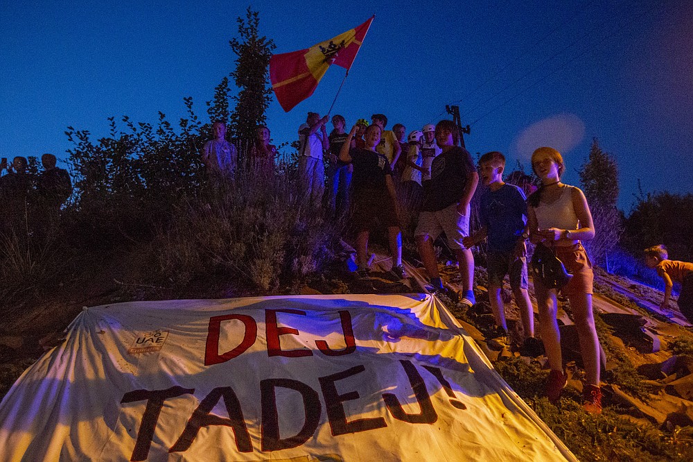 Supporters of Slovene cyclist Tadej Pogacar celebrate his victory at the Tour De France in his hometown of Komenda, central Slovenia, Saturday, Sept. 19, 2020. In an incredible climax to the Tour de France, Tadej Pogacar crushed his fellow Slovenian, Primoz Roglic, in the last stage before the finish in Paris. (AP Photo/Darko Bandic)