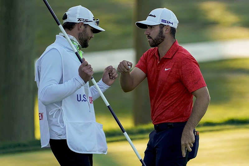 Matthew Wolff, right, bumps fists with his caddie Saturday after finishing the third round of the US Open Golf Championship in Mamaroneck, N.Y. - Photo by Charles Krupa of The Associated Press