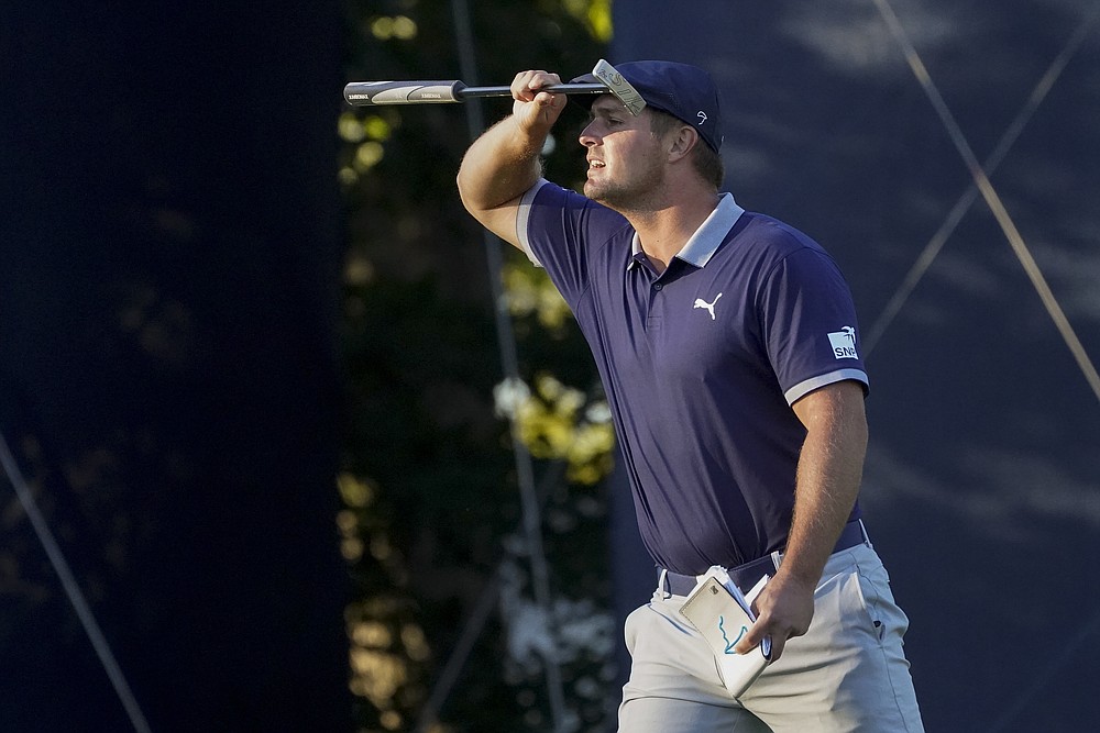 Bryson DeChambeau, of the United States, checks his lie on the 15th green during the third round of the US Open Golf Championship, Saturday, Sept. 19, 2020, in Mamaroneck, N.Y. (AP Photo/John Minchillo)