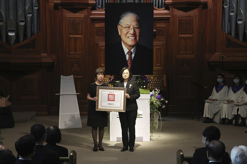 Taiwan President Tsai Ing-wen, center right, presents a posthumous citation for the late Taiwanese President Lee Teng-Hui to his daughter Anna Lee during a memorial service for the former president who led the island's transition to democracy and died at age 97 in July, in Taipei, Taiwan on Saturday, Sept. 19, 2020. (Pool Photo via AP Photo)