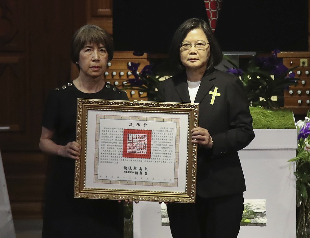 Taiwan President Tsai Ing-wen at right presents a posthumous citation for the late Taiwanese President Lee Teng-Hui to his daughter Anna Lee, during a memorial service for the former president in Taipei, Taiwan on Saturday, Sept. 19, 2020. Lee, remembered for leading the island's transition to democracy, died at age 97 in July, (Pool Photo via AP Photo)