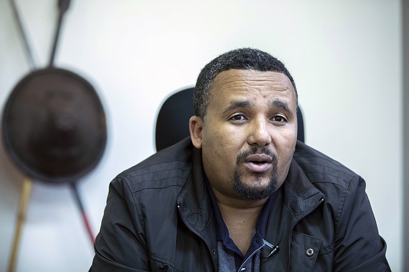 FILE - In this Thursday Oct. 24, 2019 file photo, Jawar Mohammed speaks during an interview with The Associated Press at his house in Addis Ababa, Ethiopia. Ethiopia's most prominent opposition figure, Jawar Mohammed, and 23 other people have been charged with terrorism-related offenses, telecom fraud and other criminal activities, the attorney general's office announced Saturday, Sept. 19, 2020. (AP Photo/Mulugeta Ayene, File)