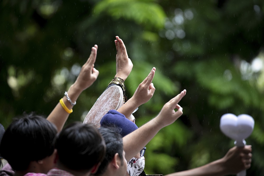 Pro-democracy protesters salute with a three-finger symbol of resistance during a protest at Sanam Luang during a protest in Bangkok, Thailand, Saturday, Sept. 19, 2020. Thousands of protesters have turned out in a student-led movement Saturday for a rally to support its demand for new elections and reform of the monarchy. (AP Photo/Wason Wanichakorn)