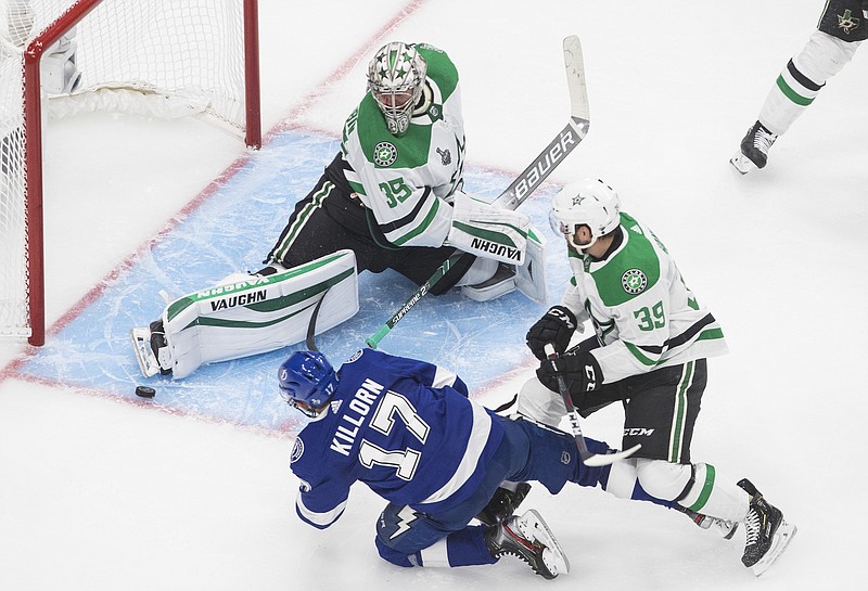 Dallas Stars goaltender Anton Khudobin (35) makes a save against Tampa Bay Lightning center Alex Killorn (17) as Dallas Stars defenseman Joel Hanley (39) defends during third-period NHL Stanley Cup finals hockey action in Edmonton, Alberta, Saturday, Sept. 19, 2020. (Jason Franson/The Canadian Press via AP)