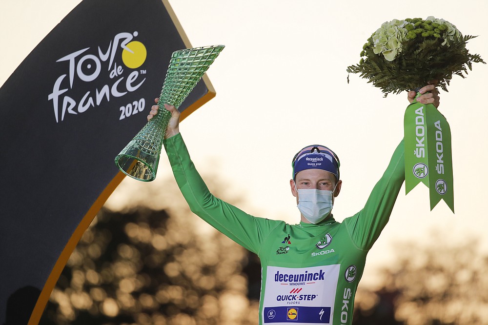 Sam Bennett of Ireland, wearing the best sprinter's green jersey, celebrates on the podium after the twenty-first and last stage of the Tour de France cycling race over 122 kilometers (75.8 miles), from Mantes-la-Jolie to Paris, France, Sunday, Sept. 20, 2020. (AP Photo/Christophe Ena)