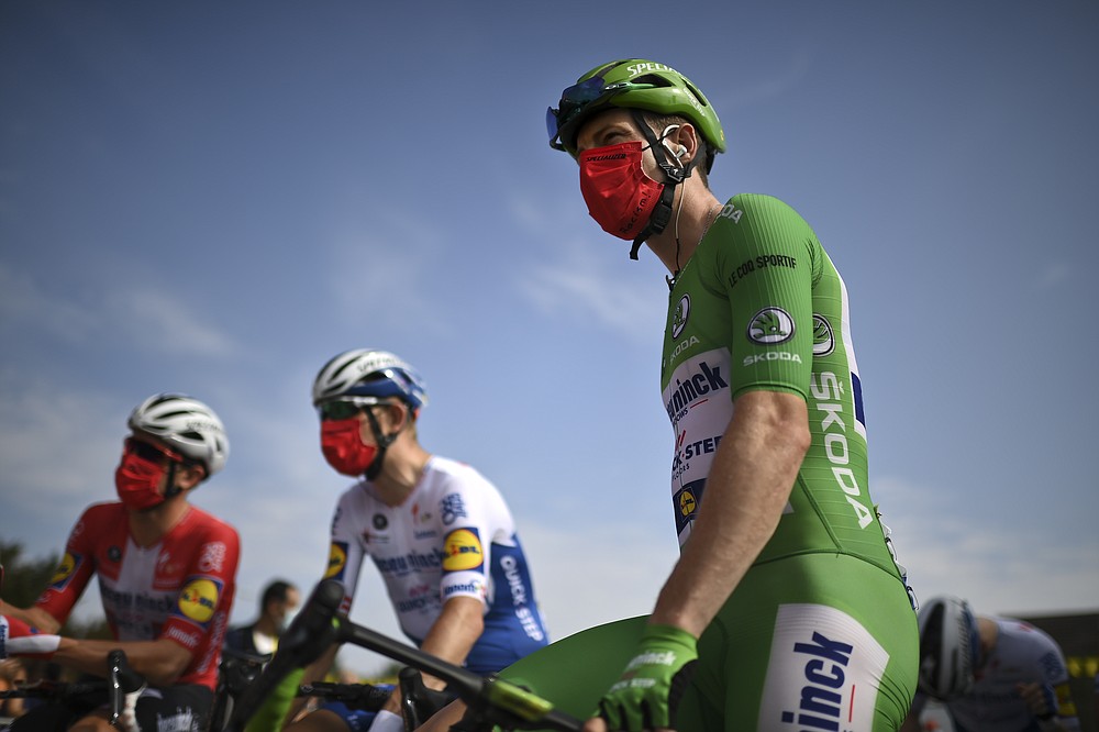 Sam Bennett of Ireland, wearing the best sprinter's green jersey, wears a face mask reading "No To Racism" as he arrives for the start of the twenty-first and last stage of the Tour de France cycling race over 122 kilometers (75.8 miles), from Mantes-La-Jolie to Paris, France, Sunday, Sept. 20, 2020. (Marco Bertorello/Pool via AP)
