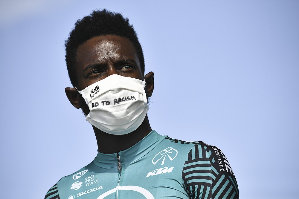 France's Kevin Reza wears a face mask reading "No To Racism" as he arrives for the start of the twenty-first and last stage of the Tour de France cycling race over 122 kilometers (75.8 miles), from Mantes-La-Jolie to Paris, France, Sunday, Sept. 20, 2020. (Marco Bertorello/Pool via AP)