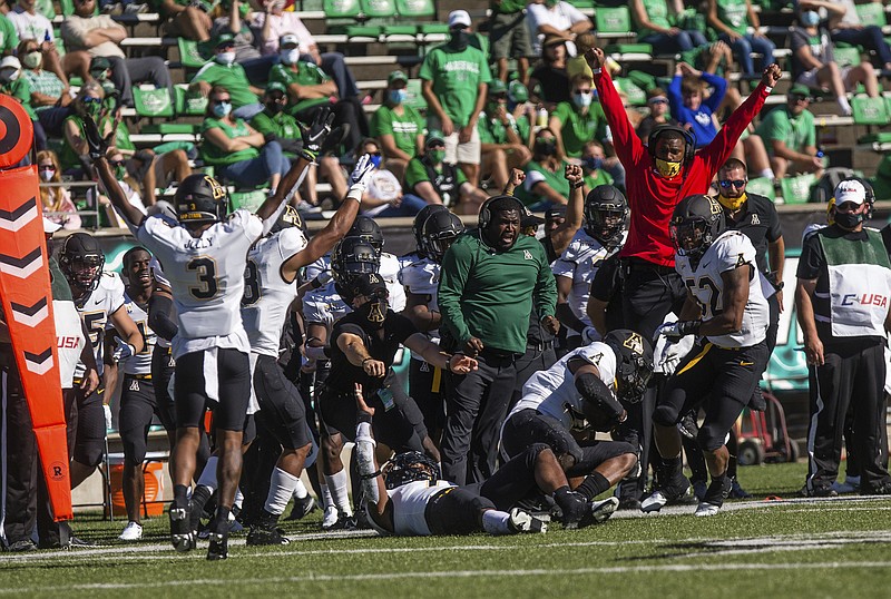 Appalachian State players celebrate an interception by safety E.J. Jackson during an NCAA college football game against Marshall Saturday, Sept. 19, 2020, in Huntington, W.Va. (Sholten Singer/The Herald-Dispatch via AP)