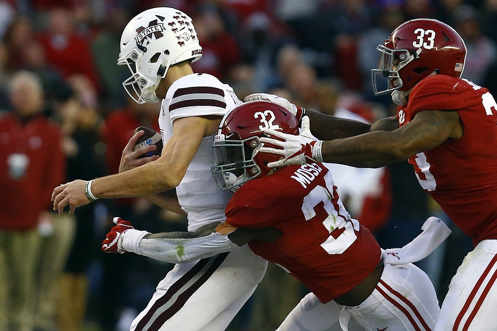 FILE - In this Nov. 10, 2018, file photo, Mississippi State quarterback Nick Fitzgerald (7) is sacked by Alabama linebacker Dylan Moses (32) and linebacker Anfernee Jennings (33) during the second half of an NCAA college football game, in Tuscaloosa, Ala. Dylan Moses is a candidate for the Bednarik Award, as the defensive player of the year. (AP Photo/Butch Dill, File)