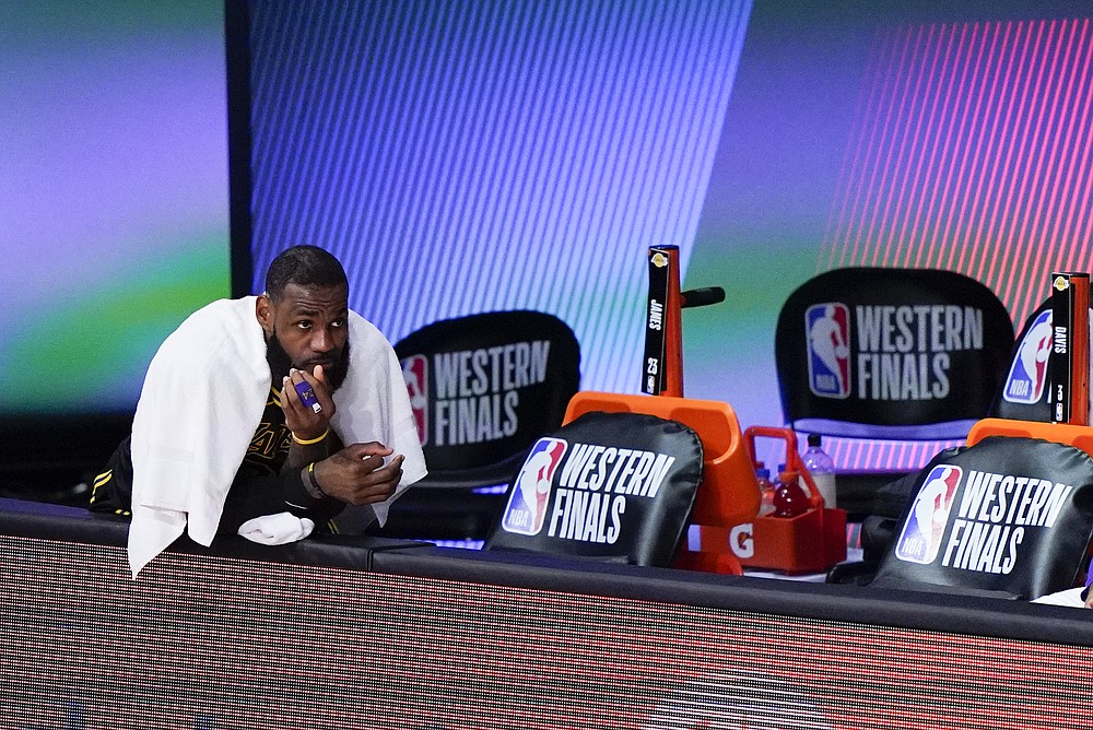 Los Angeles Lakers' LeBron James sits on the bench during the second half of an NBA conference final playoff basketball game against the Denver Nuggets Sunday, Sept. 20, 2020, in Lake Buena Vista, Fla. (AP Photo/Mark J. Terrill)