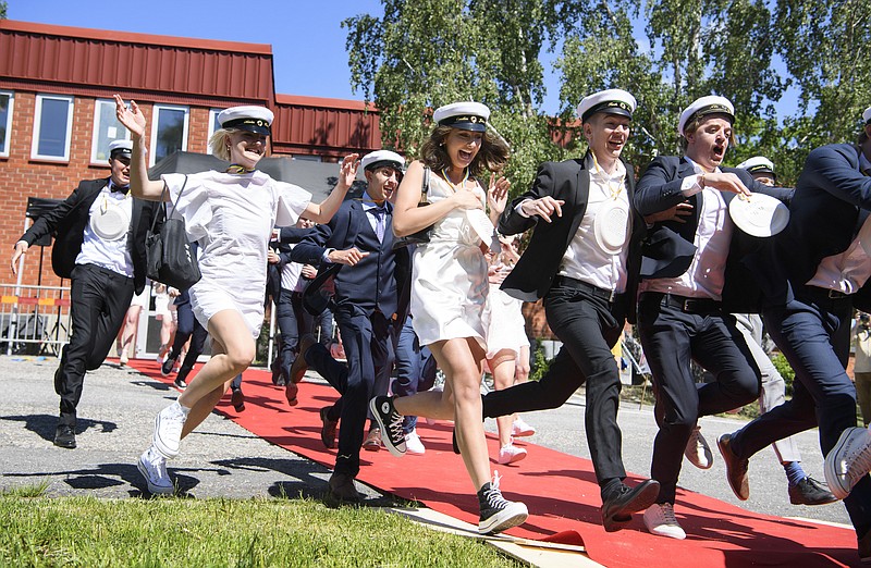 FILE - In this Wednesday June 3, 2020 file photo students run celebrating their high school graduation at Nacka Gymnasium in Stockholm, Sweden. Sweden's relatively low-key approach to coronavirus lockdowns captured the world's attention when the pandemic first hit Europe. (Jessica Gow / TT via AP, File)